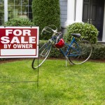 Why FSBO’s Fail Closeup view of Modern Suburban Home with for Sale Real Estate Sign in front yard and bicycle and house in background